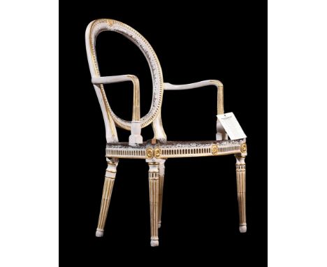 A GEORGE III CREAM PAINTED AND PARCEL GILT ELBOW CHAIRIN THE MANNER OF THOMAS CHIPPENDALE, CIRCA 1780The seat rail numbered w