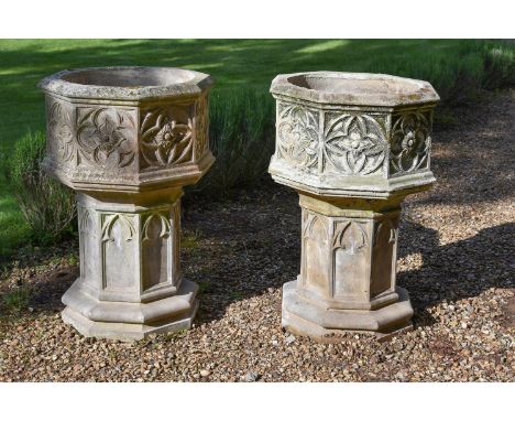 A PAIR OF CAST STONE PLANTERS AND PEDESTALS IN THE GOTHIC STYLE, 20TH CENTURY Octagonal jardinières on gothic arch decorated 