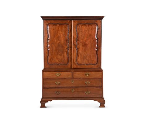 A GEORGE II MAHOGANY CLOTHES PRESSIN THE MANNER OF GILES GRENDEY, CIRCA 1750The doors enclosing three sliding trays181.5cm hi