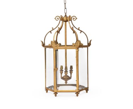 A GILT METAL HALL LANTERN IN THE REGENCY STYLE, 20TH CENTURY Of hexagonal form with acroteria mounts 61cm high, 39cm wide