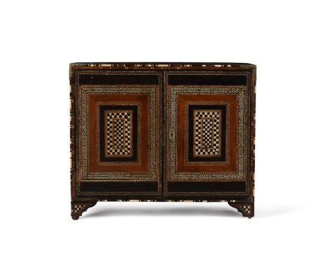 Y A NASRID ROSEWOOD, EXOTIC HARDWOOD,EBONY AND BONE INLAID TABLE CABINETLATE 15TH/ 16TH CENTURYThe doors opening to an arrang