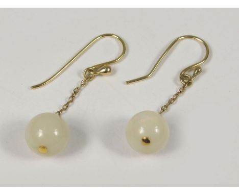 OPAL EARRINGS. A pair of opal pendant earrings suspended on 9ct. chains &amp; with hand made hooks. Approx. 10ct.