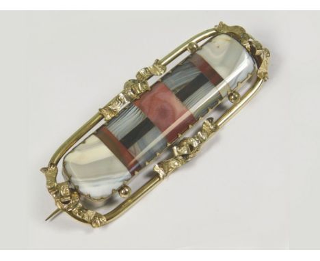 HARDSTONE PIN. A Victorian Scottish hardstone cloak pin of polished pink & grey natural hardstones, within a typical gilt met