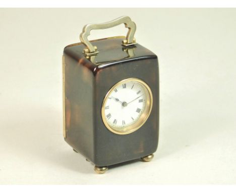 MINIATURE CLOCK. An early 20th century, 9ct. gold mounted tortoiseshell miniature carriage clock by William Comyns & Sons Ltd