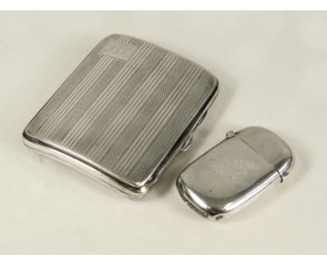 VESTA ETC. A Victorian engraved silver vesta case & a 1920's curved, engine turned silver cigarette case.