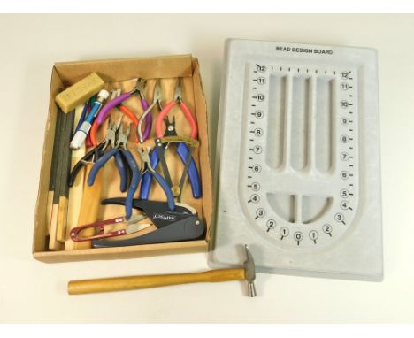 JEWELLERY TOOLS. A selection of jewellery tools &amp; a bead design board.