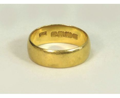WEDDING BAND. A broad 22ct. gold wedding band. Approx. 5.1g. Size K.