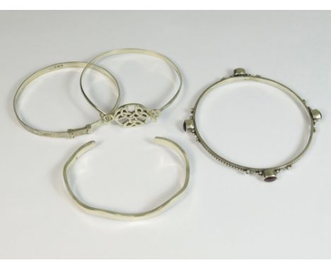 SILVER BANGLES ETC. A modern silver torque bracelet, an engraved silver bangle & two other silver coloured metal bangles, one