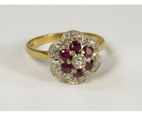 GOLD RING. An 18ct. gold ruby &amp; diamond cluster ring, the diamonds illusion set. Size L/M.