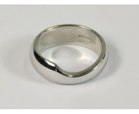 WEDDING BAND. A 14ct. white gold, shaped, modern wedding band. Approx. 5.4g. Size K. NOTE: This wedding band is designed to f