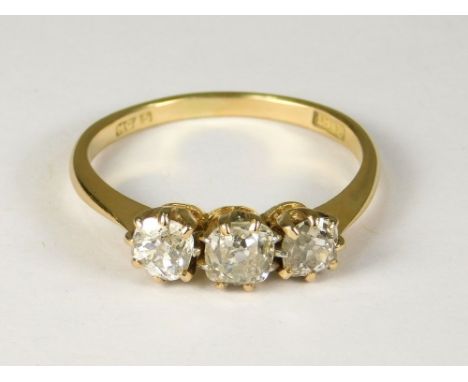 DIAMOND RING. An 18ct. gold three stone diamond ring, set with old cushion-shaped, brilliant cut diamonds. Estimated total di