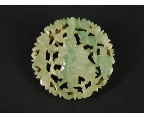 JADE BROOCH. A Chinese jade brooch, pierced with an immortal, an animal, flowers &amp; leaves. Yellow metal brooch attachment