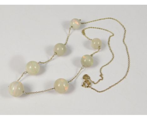 OPAL NECKLACE. An Edwardian opal necklace with seven graduated opals on 9ct. gold chain. Opal total approx. 48ct.