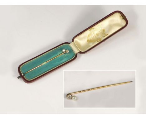 STICK PIN.A stick pin set a clear stone & hung a cultured pearl drop, in fitted Edward Tessier case.