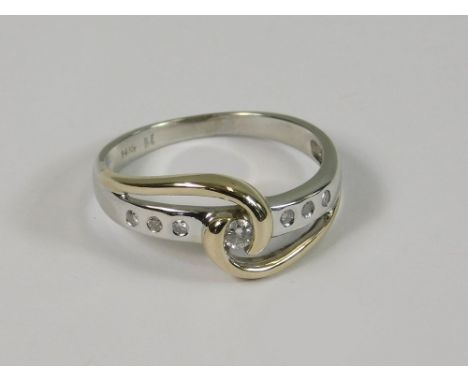 DIAMOND RING. A 14ct. white &amp; yellow gold ring, set with seven diamonds. Approx. 2.6g. Size K. NOTE: This engagement ring