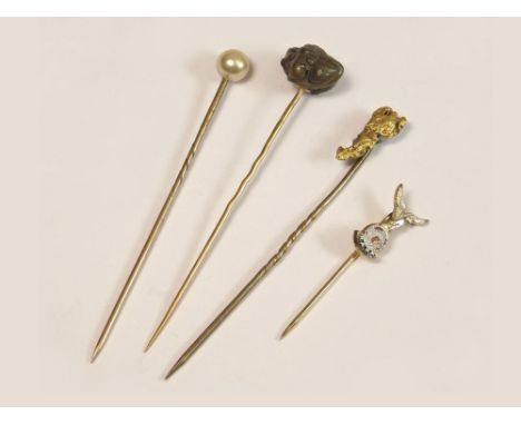 STICK PINS. Four various stick pins including an 18ct. gold carved ram's head stick pin &amp; a gold nugget stick pin.