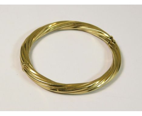 GOLD BANGLE. A 9ct. gold hinged bangle, filled.