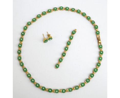 A decorative jade coloured necklace, expanding loose section and pair of ear studs.