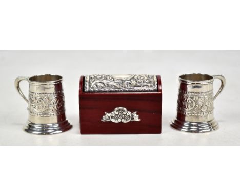 A pair of Continental sterling silver tot cups in the form of mugs, with foliate scroll decoration, and an Italian silver top