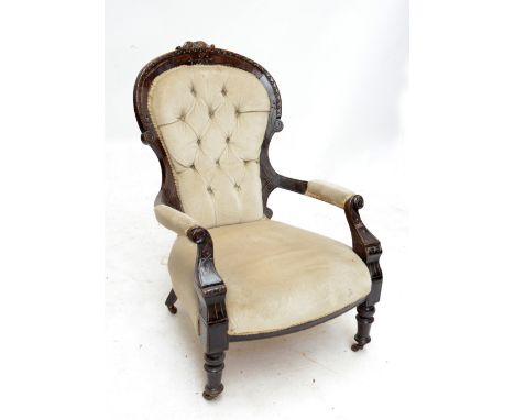 A late Victorian stained beech button upholstered open armchair raised on ring turned front legs.