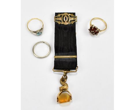 An 18ct white gold wedding band, size K, approx 3g, two 9ct yellow gold dress rings, approx 5.3g and a ribbon set with fob (4