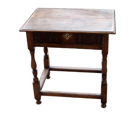 An 18th century oak side table with carved detail to the frieze drawer and raised on baluster ring turned and block legs unit