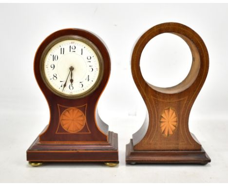 An Edwardian mahogany and inlaid mantel clock, the circular enamelled dial set with Arabic numerals, raised on four brass fee