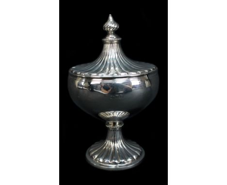 HOLLAND, ALDWINCKLE &amp; SLATER; a George V hallmarked silver lidded sugar bowl with gadrooned detail and knopped stem on sp