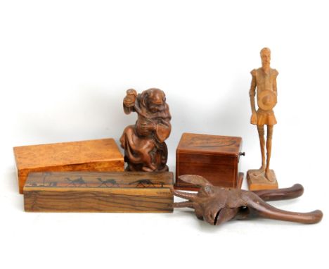 An early 20th century Black Forest nutcracker in the form of an ibex (af), two further carved wooden figures, an olive wood l