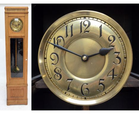 A mid-20th century oak longcase clock, the circular brass dial set with Arabic numerals and with glazed door, height 208cm.