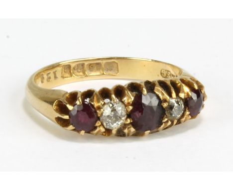 An 18ct yellow gold diamond and ruby five stone ring, size O, approx 4.9g.