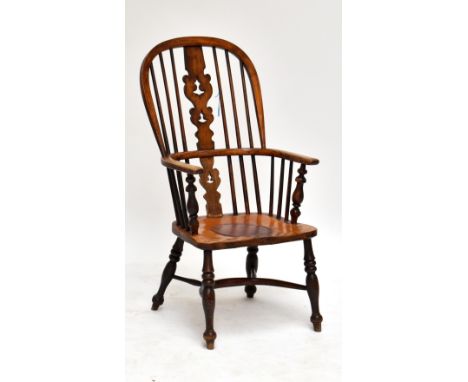 A 19th century ash and elm high hoop back Windsor elbow chair with crinoline stretcher, the seat converted at one stage to a 