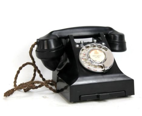 A vintage bakelite telephone.Additional InformationPostage of this lot will cost £22 + VAT within the UK.