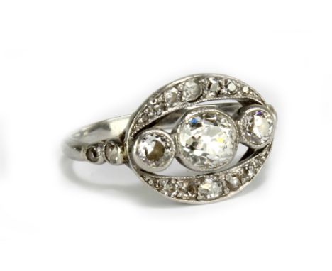 A platinum and diamond Art Deco design ring of open oval form, the central stone approx 0.75ct, within a framework of further