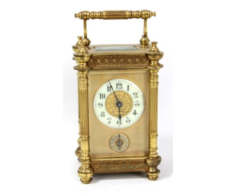 A late 19th century brass cased carriage clock, the porcelain dial set with Arabic numerals and subsidiary seconds dial, the 