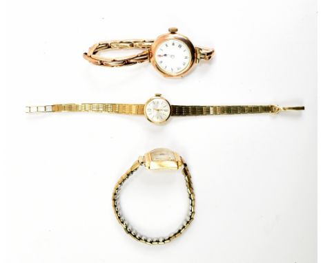 A 9ct rose gold lady's vintage wristwatch on expandable strap and two further 9ct yellow gold ladies' watches, one with integ