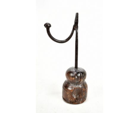 An 18th century wrought iron rush light with turned wooden base, height 28cm.