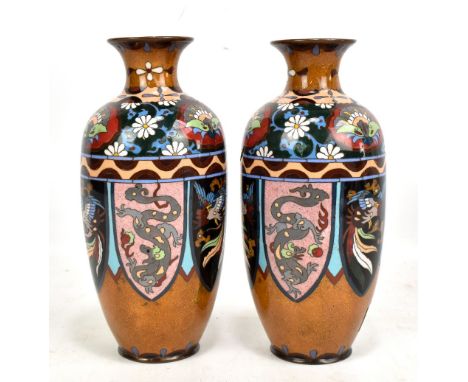 A pair of early 20th century Japanese cloisonne enamel orange ground vases decorated with floral bands above alternating drag
