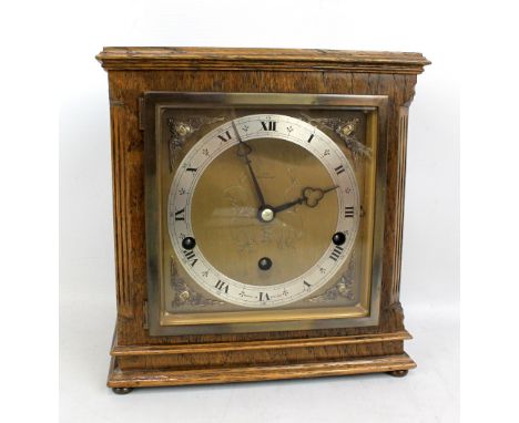 ELLIOTT; an oak cased eight day lever Westminster and Whittington chime clock, the silvered chapter ring with Roman and Arabi