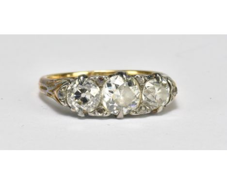 An Edwardian 18ct yellow gold three stone diamond ring, the central stone weighing approx 0.75ct flanked by twin 0.50ct diamo