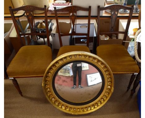 A set of three Edwardian rosewood and inlaid bedroom chairs with ring-turned front legs and a gilt-framed convex mirror, diam