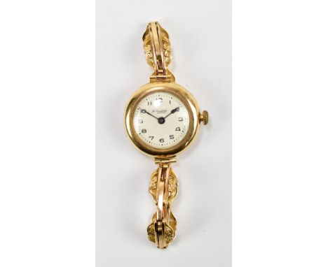 A lady's 15ct yellow gold vintage wristwatch with circular dial set with Arabic numerals, inscribed 'Thos. Russell &amp; Son'
