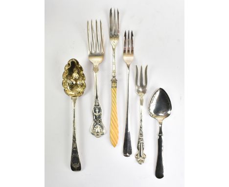 An American sterling silver pickle fork, a silver-gilt small berry spoon, a sterling silver fork, two further pickle forks, o