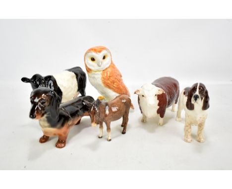 BESWICK; six animal figures with two cows including 'CH of Champions', dachshund, spaniel, donkey and owl (6).Additional Info