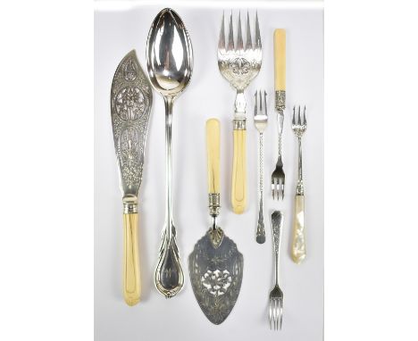 A late Victorian hallmarked silver pickle fork, also a pair of plated fish servers, a plated cake slice, a plated serving spo