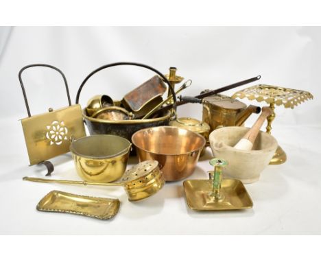 A quantity of metalware, predominantly brass including trivet, chamber stick, small preserve pot, candle holder etc.