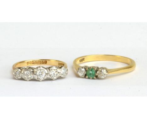 An 18ct yellow gold five stone diamond ring, size M and an 18ct yellow gold emerald and diamond three stone ring, size T, app