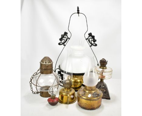 An Art Nouveau ceiling light with white opaque glass shade, a pierced wrought iron based oil lamp and four further lamps (6).