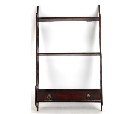 A mahogany three tier wall shelf with single drawer to base, length 41cm.Additional InformationThis is modern.