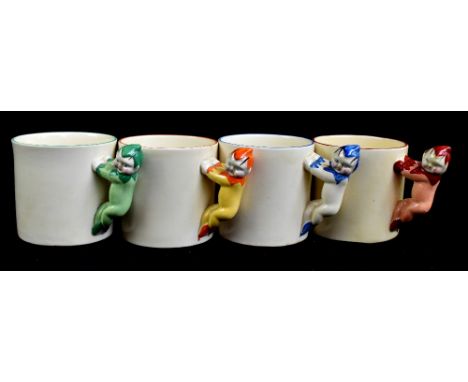 CLARICE CLIFF; four 'Pixie Ware' mugs with handles modelled as pixies in green, blue, red and orange colourways, two for Newp